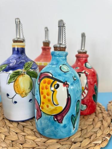 a group of four bottles sitting on a basket at Hotel Albatros in Ischia