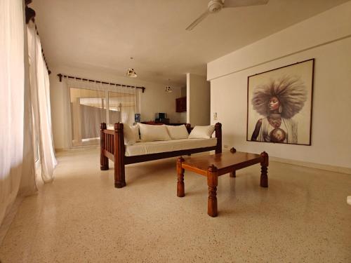 a living room with a couch and a coffee table at Le Pleiadi in Malindi