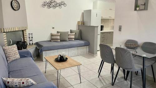 a living room with a couch and a table at Mina’s house in Amarinthos