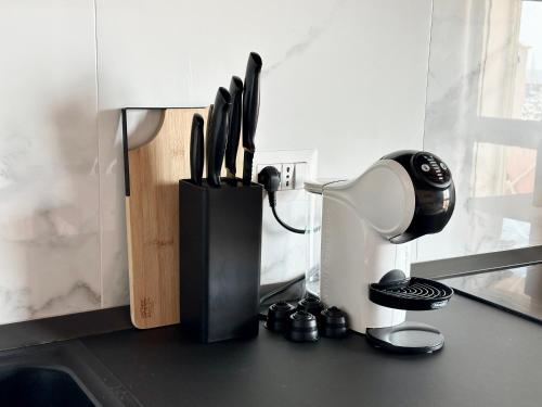 a black holder with utensils on a kitchen counter at Approdo Apartments in Isola Rossa