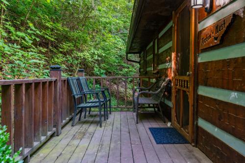 two chairs sitting on a porch of a house at The Robins Nest with hot tub in Pigeon Forge