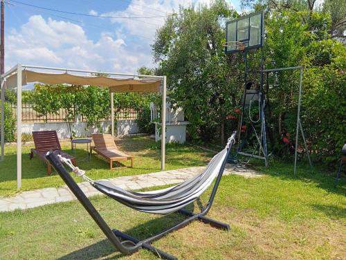a hammock in a yard with a basketball hoop at Green Vila in Sozopoli