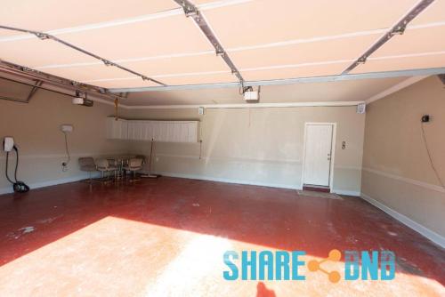 an empty room with a red floor at Elegant Lakefront Home W Covered Patio in Little Rock