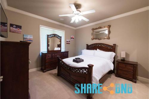 a bedroom with a bed and a ceiling fan at Elegant Lakefront Home W Covered Patio in Little Rock