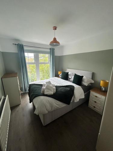 a bedroom with a large bed and a window at Saffron Loft, Belfast in Belfast