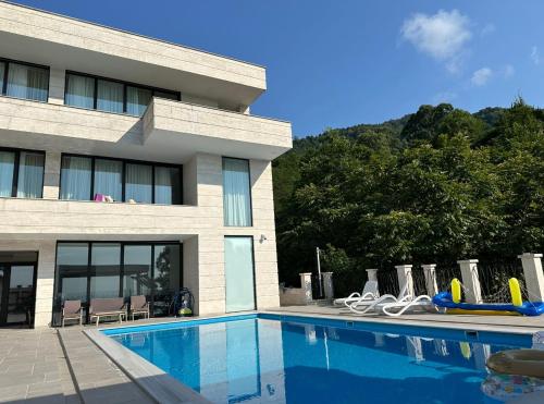 a swimming pool in front of a building at Villa Sunlight in Gonio