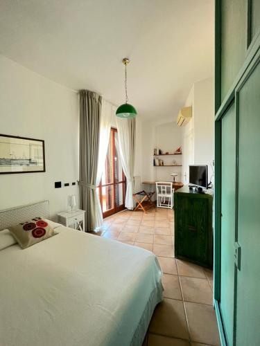 a bedroom with a white bed in a room at VelaLatina Residence B&B Soverato - Camera Maestrale & Camera Tramontana in Soverato Marina