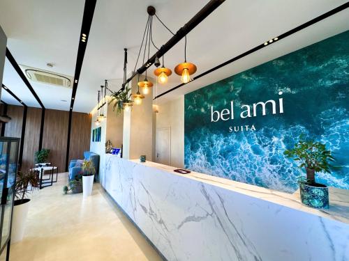 an office lobby with a large sign on the wall at Bel Ami Suita Hotel in Vlorë