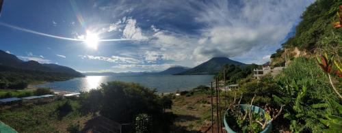 a view of a lake with the sun in the sky at Nanzales in San Pablo La Laguna