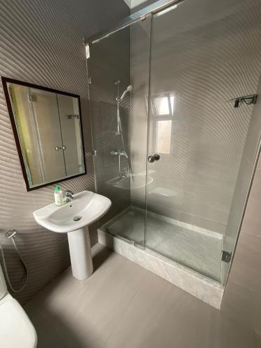 a bathroom with a sink and a glass shower at Villa Royale Prestige Safaa in Dar Bouazza