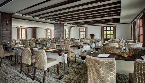 a dining room with tables and chairs and windows at Four Seasons Hotel Casa Medina Bogota in Bogotá