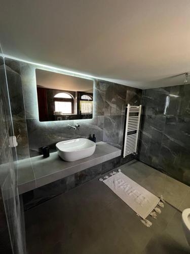 a bathroom with a sink and a mirror at Blue Olive House & Studio in Artemida
