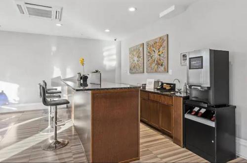 a kitchen with a counter and a bar with a refrigerator at XL Studio - Premier Studio with Gym Access in Philadelphia