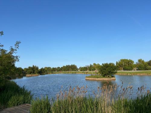 a large lake with a island in the middle at Disabled caravan -ramped decking - Grange Leisure Park, Mablethorpe - Pet friendly and Wifi - Meadow Lakes Caravan & Lodge Hire in Mablethorpe