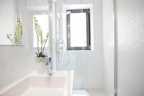 a white bathroom with a sink and a shower at Mallorca Villa 1463: Relax in Your Private Oasis in Deia