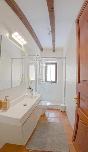a white bathroom with a sink and a toilet at Mallorca Villa 1463: Relax in Your Private Oasis in Deia