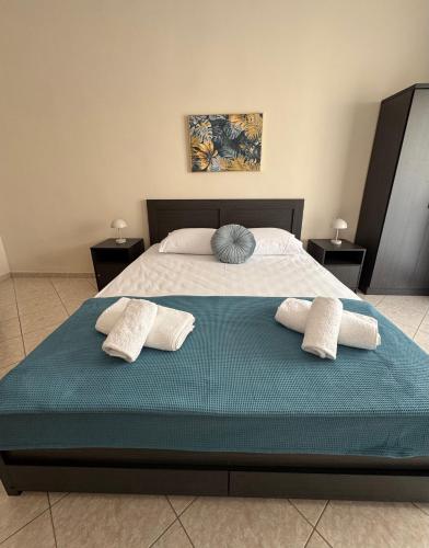a bedroom with a large bed with two pillows at Lina Home in Drama