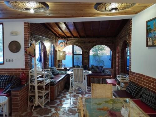 a room with chairs and tables and windows at AYMANE ROOFTOP budget panoramic HOTEL in Chefchaouene