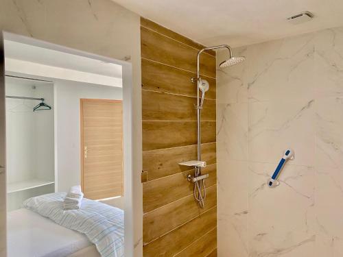 a bathroom with a walk in shower next to a walk in shower at Chambres d'hôtes - La correziene in Allassac