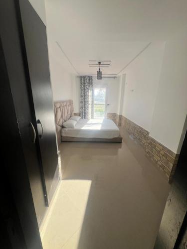 a bedroom with a bed in the middle of a room at Apparemment saidia ap13 in Saidia 