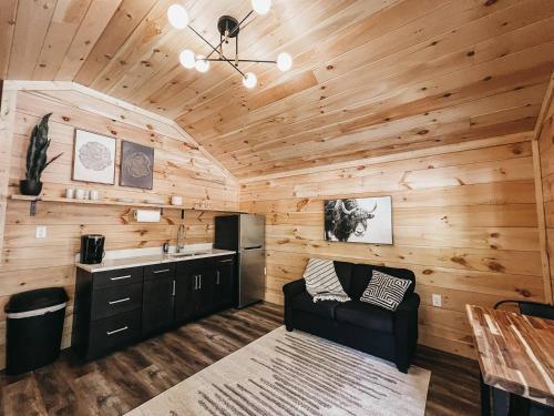 a kitchen and living room in a log cabin at Cabin #10 One Bedroom With Kitchenette in Hartwell