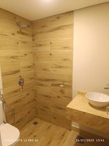 a bathroom with a toilet and a sink at La Perla in Encarnación
