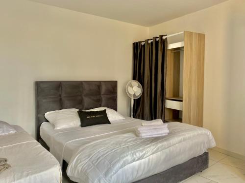 a bedroom with two beds and a lamp in it at Chambres d'hôtes - La correziene in Allassac