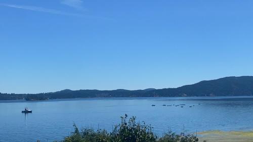 a boat in the middle of a large lake at Beachbreeze Panoramic Oceanview 4BR 3BA Romantic Sunrise & Celestial Views in Mill Bay