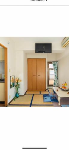a living room with a door and a table at 都心の家30 square meter king size bed, step meter, 3-person room201 in Tokyo