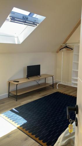 a living room with a table and a skylight at Sintra Flower Vintage Chalet in Sintra