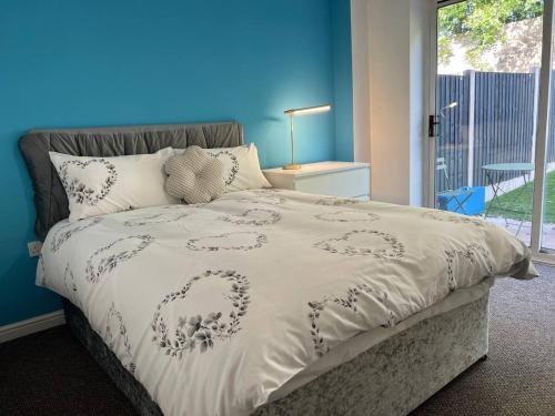 a bed with a white comforter with a heart on it at Etruria House - Near Water World, Festival Park and Bet365 in Stoke on Trent