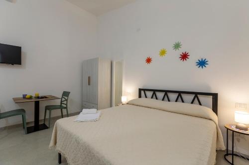 a bedroom with a bed and a desk and a television at Azienda Agrituristica Spicchio di Sole in Bernalda