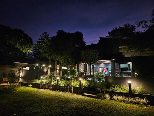 a house with lights in a yard at night at Amoya Villa in St Lucia