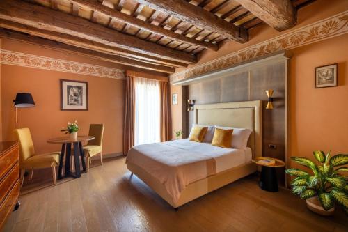 a bedroom with a bed and a table and chairs at Palazzo De Gregorio - Apartments in Palermo