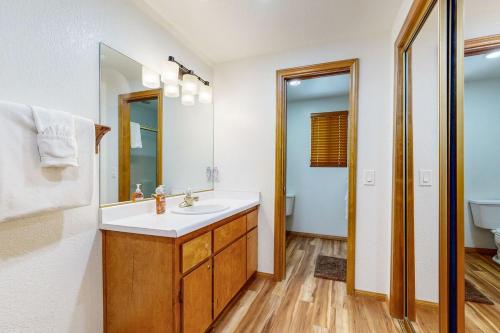 a bathroom with a sink and a mirror at Quiet Cabin ~ End of Cul-De-Sac Location Private Hot Tub, Fenced Yard, Boat Parking in Big Bear Lake