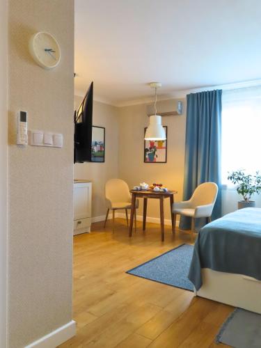 a room with a bed and a table and chairs at Apartament Studio 220 in Biała Podlaska