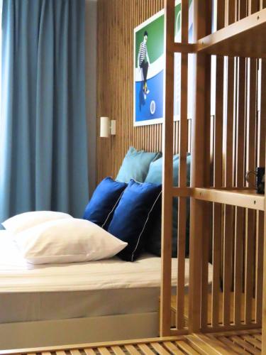 a bedroom with a bed with blue pillows at Apartament Studio 220 in Biała Podlaska