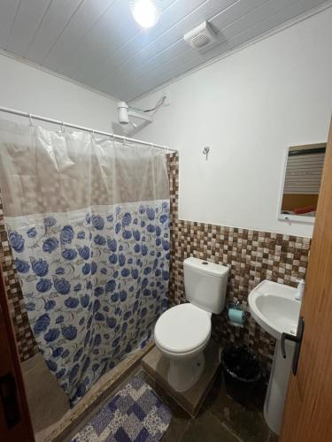 a bathroom with a toilet and a sink at Hotel da Vila in Nova Friburgo