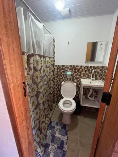 a bathroom with a toilet and a sink at Hotel da Vila in Nova Friburgo