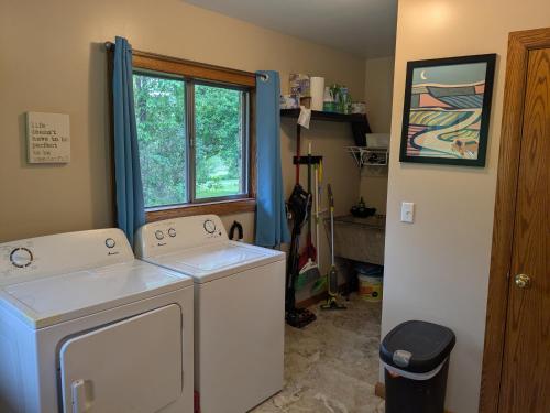 a laundry room with two washing machines and a window at Scenic Solitude in Dryfork