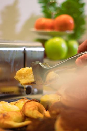 a person is eating food with a spatula at Hotel Ramos Mejía in Mar del Plata
