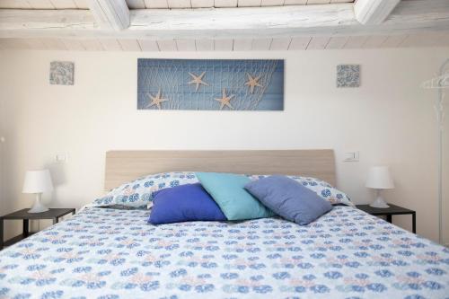 a bedroom with a bed with pillows on it at L'Oasi del Tirreno in Lascari