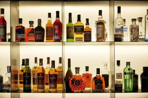 a display case filled with lots of bottles of alcohol at Four Seasons Hotel Bogota in Bogotá