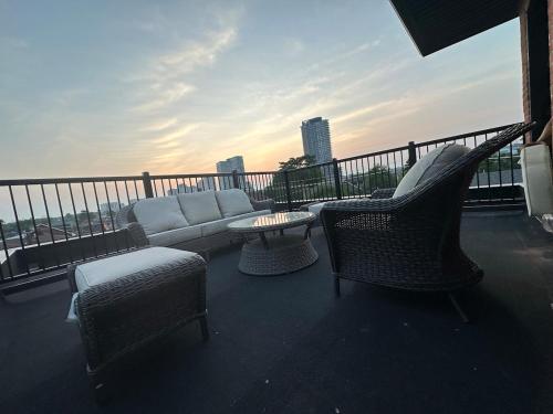 a balcony with a couch and chairs and a table at Mins from Toronto Downtown UFT Exhibition Place in Toronto