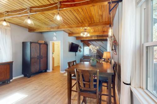 a dining room with a wooden table and chairs at The Summit at Sherwood ~ Dog-friendly cabin with fenced yard, patio, grill, & furnished deck in Big Bear City