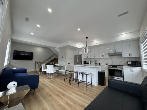 a kitchen and living room with a blue couch at Mins from Toronto Downtown UFT Exhibition Place in Toronto