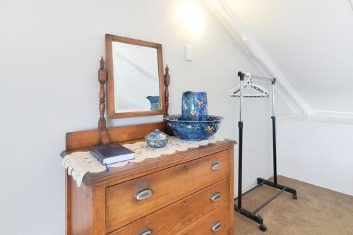 a dresser with a mirror on top of it at Hugo Haven in Bredasdorp