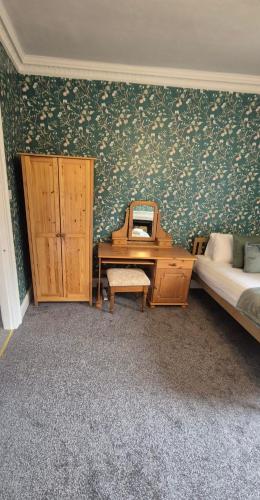 a bedroom with a desk next to a bed and a desk at Beautiful 4BR Georgian house in Wisbech