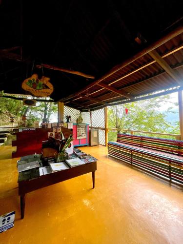 a room with a table in the middle of a room at Minca Ecohabs Hotel in Minca