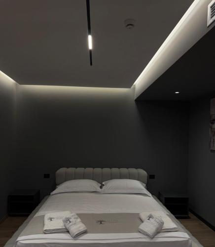 a bedroom with a bed with two towels on it at Hotel Lezha Park in Ishull-Lezhë